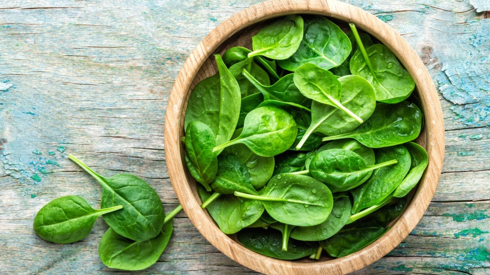 a bowl of bright green spinach.